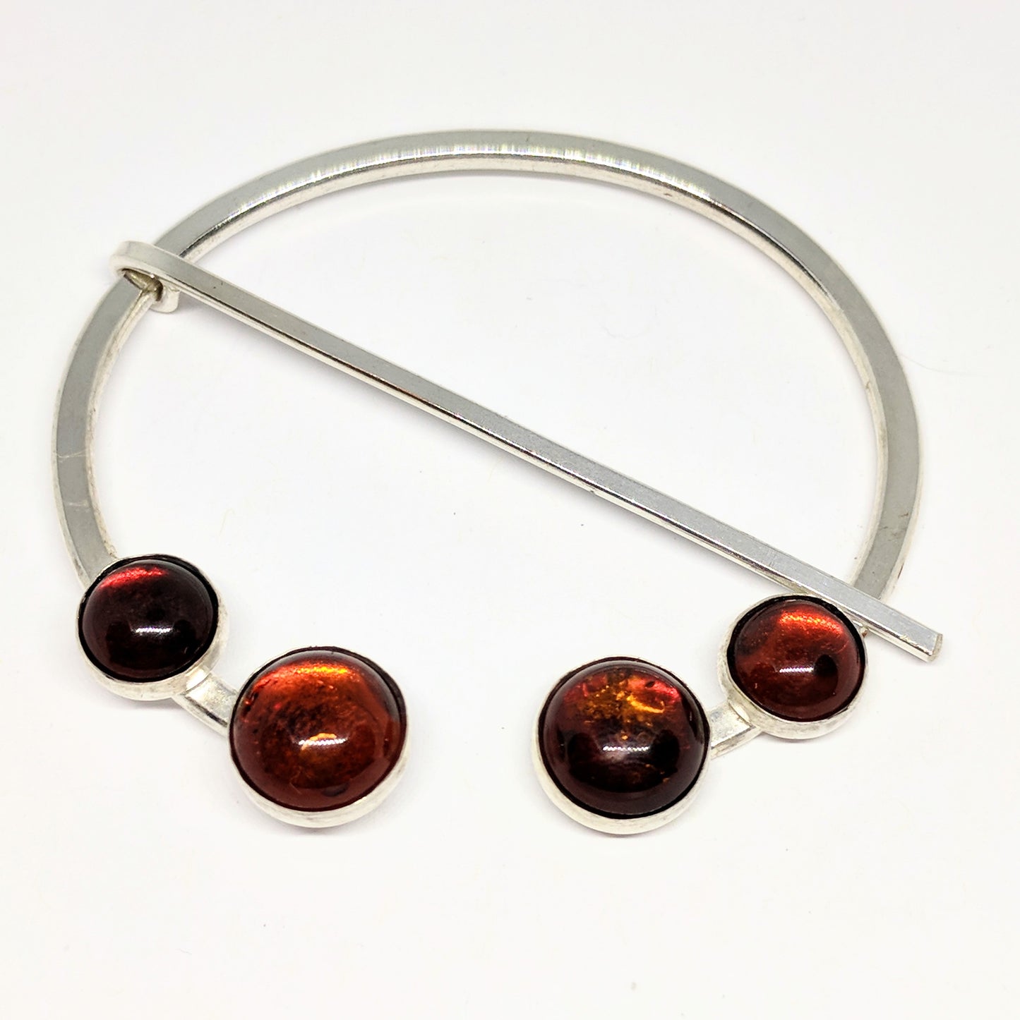 Large amber penannular pin